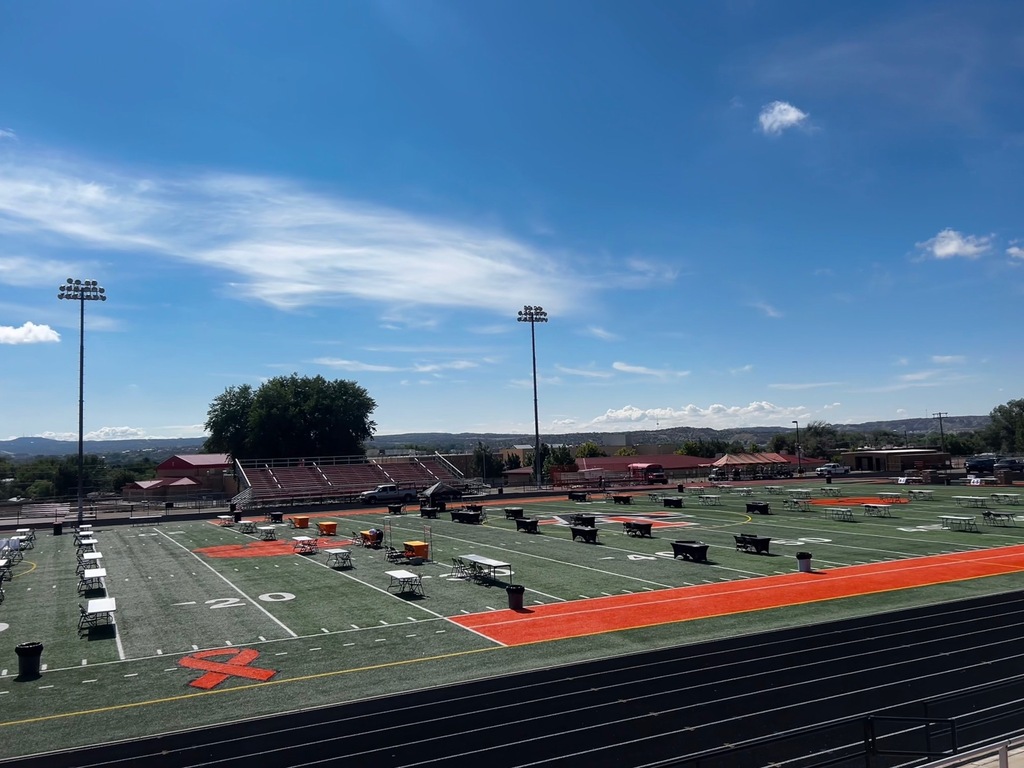Staff and volunteers prepare tables, booths, and decorations for the Tiger Summit ahead of the event starting at 4:00 PM.
