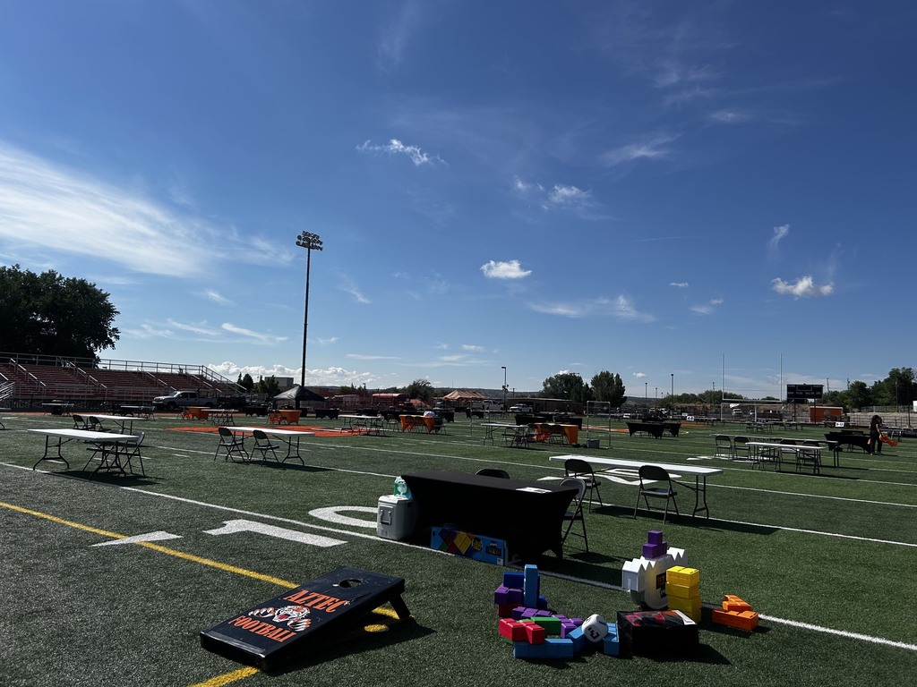 Staff and volunteers prepare tables, booths, and decorations for the Tiger Summit ahead of the event starting at 4:00 PM.
