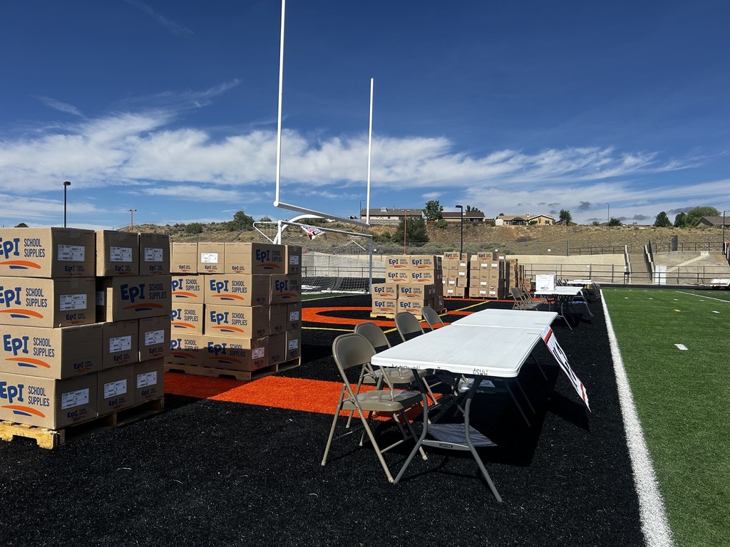 Staff and volunteers prepare tables, booths, and decorations for the Tiger Summit ahead of the event starting at 4:00 PM.