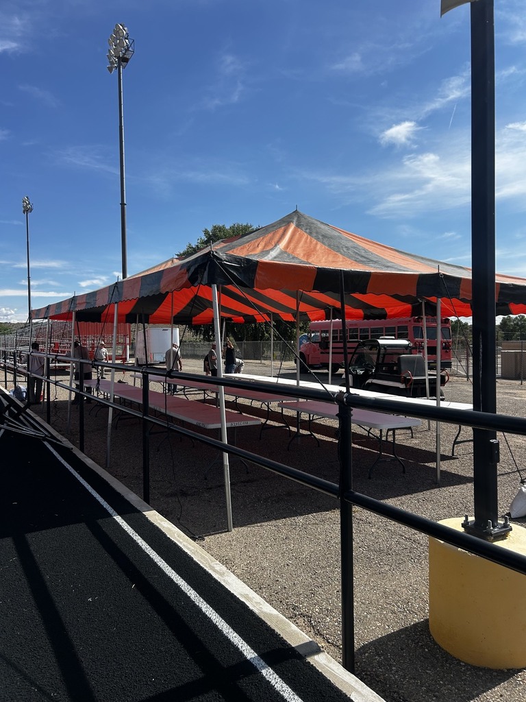 Staff and volunteers prepare tables, booths, and decorations for the Tiger Summit ahead of the event starting at 4:00 PM.