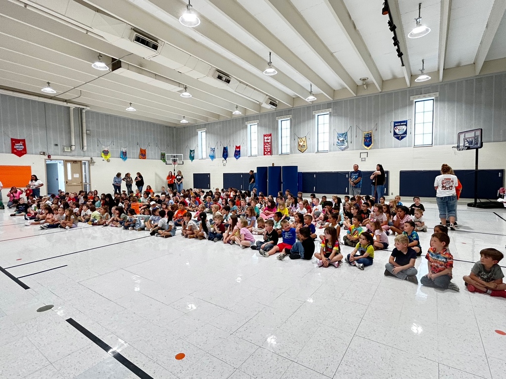 McCoy Elementary students gather in the gym as staff share information about the school’s fundraiser. Students sit together and listen during the fundraiser kickoff.