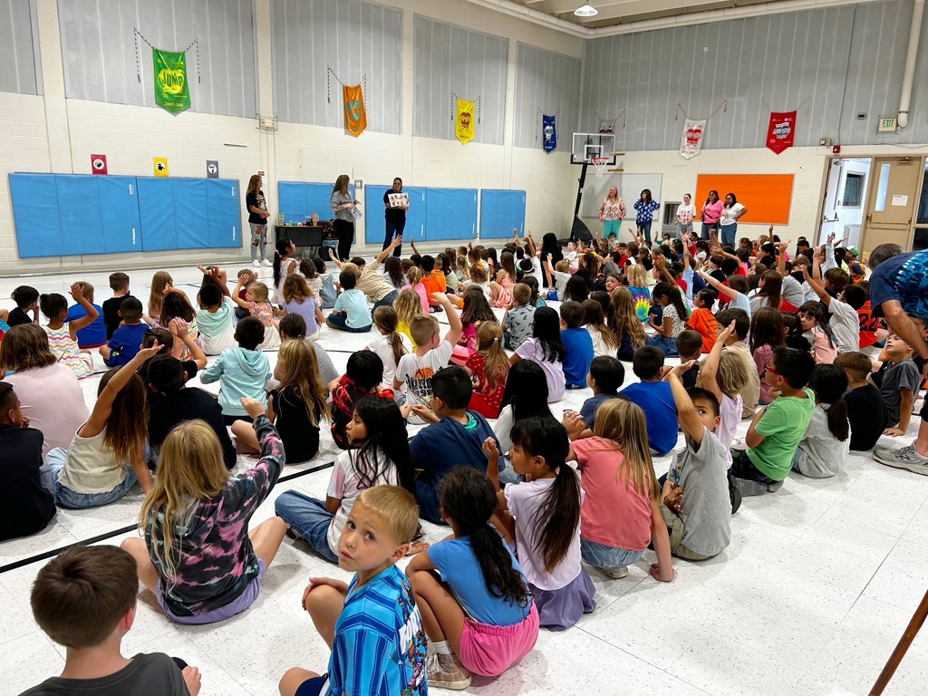 McCoy Elementary students gather in the gym as staff share information about the school’s fundraiser. Students sit together and listen during the fundraiser kickoff.