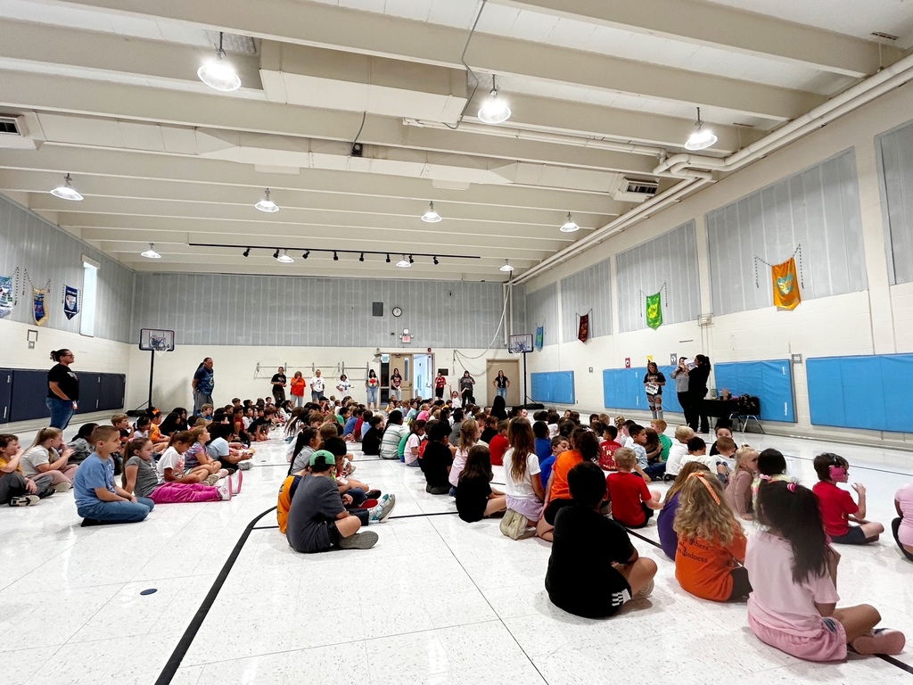 McCoy Elementary students gather in the gym as staff share information about the school’s fundraiser. Students sit together and listen during the fundraiser kickoff.