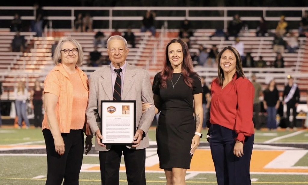 Photos from Friday night's Aztec Schools Hall of Honor induction ceremony, featuring 2026 inductees Jesse Russell, Bill Francis, and J. Jacob Saiz being recognized on the football field. Additional photos show plaques honoring each inductee. Photos by Landry Bentley.