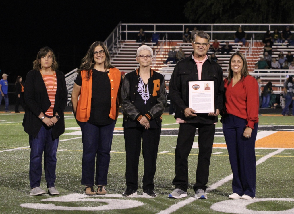 Photos from Friday night's Aztec Schools Hall of Honor induction ceremony, featuring 2026 inductees Jesse Russell, Bill Francis, and J. Jacob Saiz being recognized on the football field. Additional photos show plaques honoring each inductee. Photos by Landry Bentley.