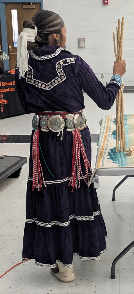 Photos from the annual Miss and Mr. Aztec High School Pageant. Students showcase traditional Navajo clothing, cultural regalia, and pageant sashes. The photos include a Miss Aztec High School titleholder, a student speaking into a microphone, a student holding traditional wooden sticks, and two pageant participants posing with bouquets of flowers.