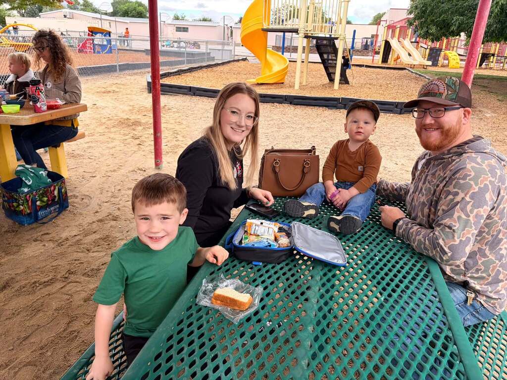 McCoy Avenue Elementary kindergarten students and their families enjoy a picnic together on the playground during Friday’s Kindergarten Family Picnic.
