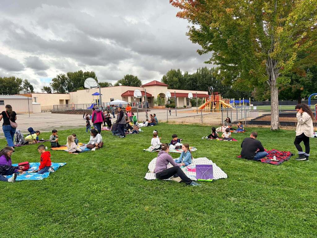 McCoy Avenue Elementary kindergarten students and their families enjoy a picnic together on the playground during Friday’s Kindergarten Family Picnic.