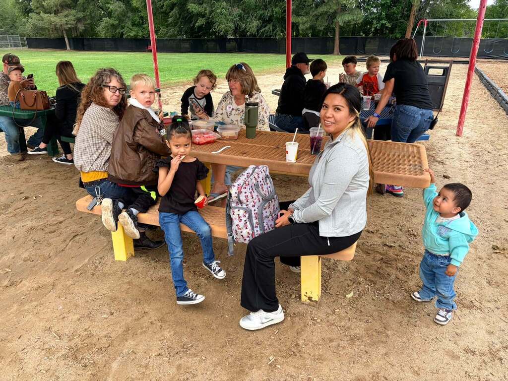 McCoy Avenue Elementary kindergarten students and their families enjoy a picnic together on the playground during Friday’s Kindergarten Family Picnic.