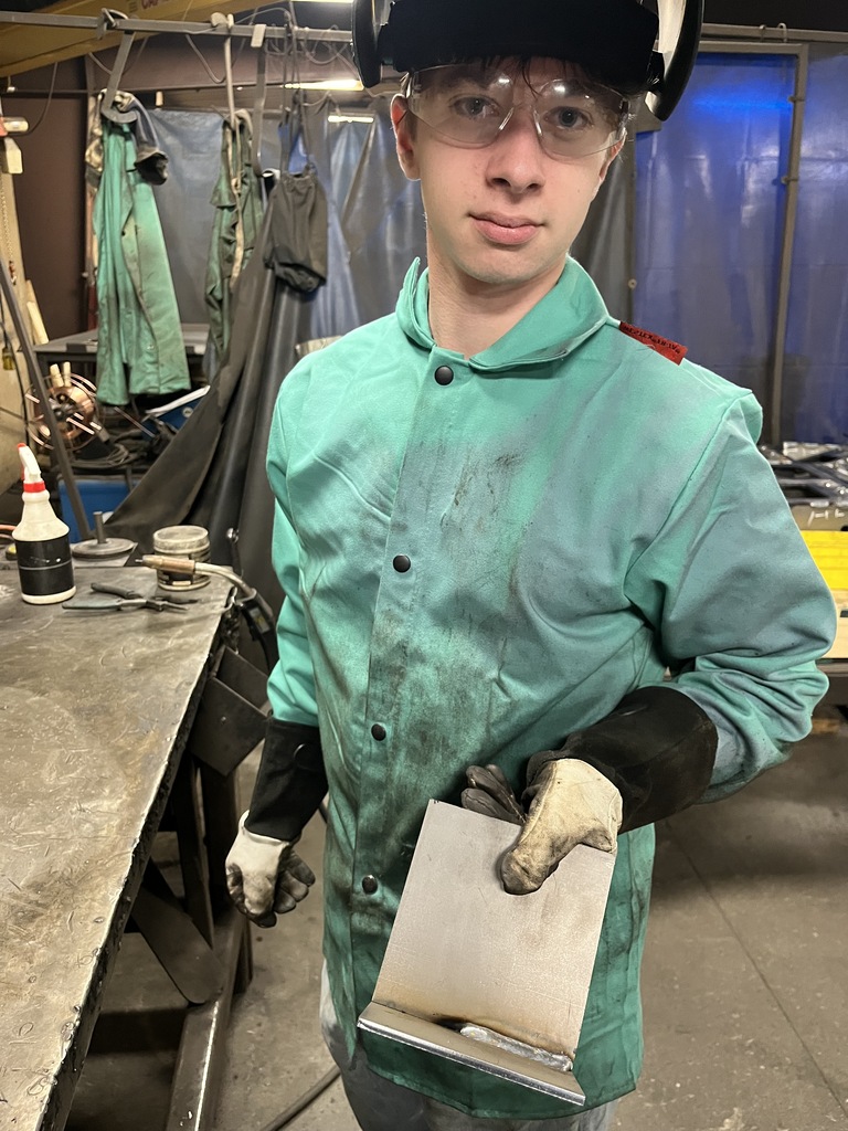 A student interns at a welder