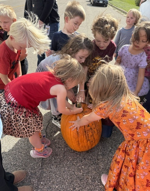 Students carve a pumpkin