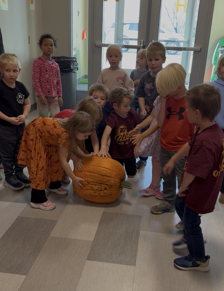Students measure a pumpkin
