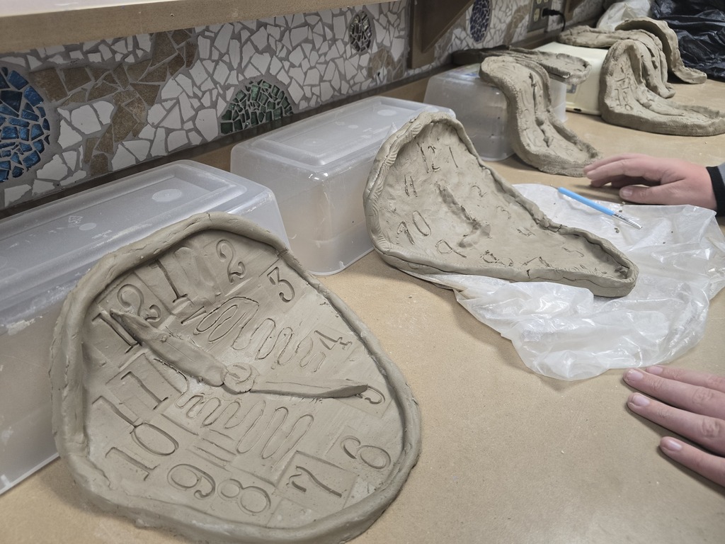 8th grade art students used clay to create their own clocks that appear to be melting