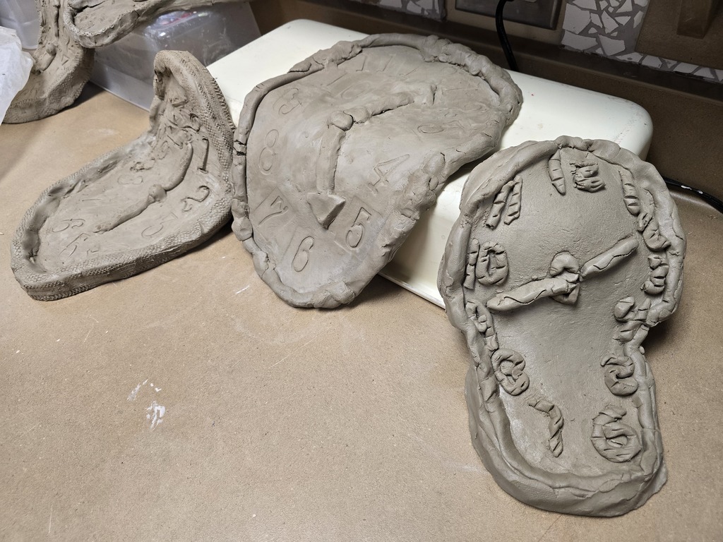 8th grade art students used clay to create their own clocks that appear to be melting