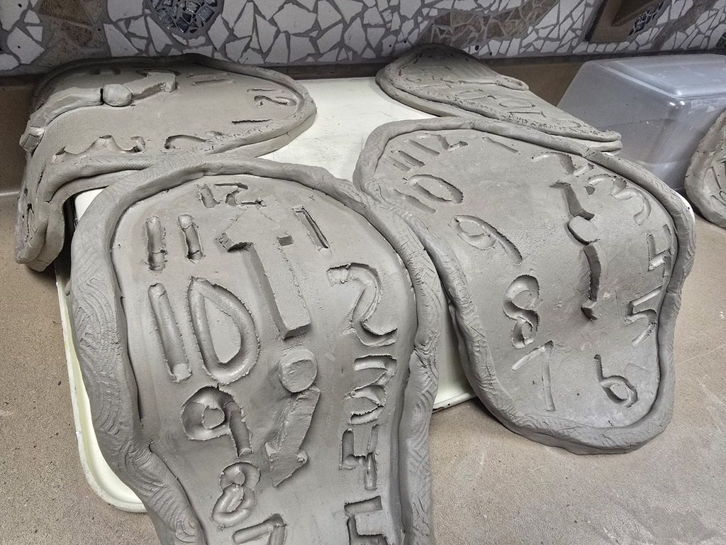 8th grade art students used clay to create their own clocks that appear to be melting