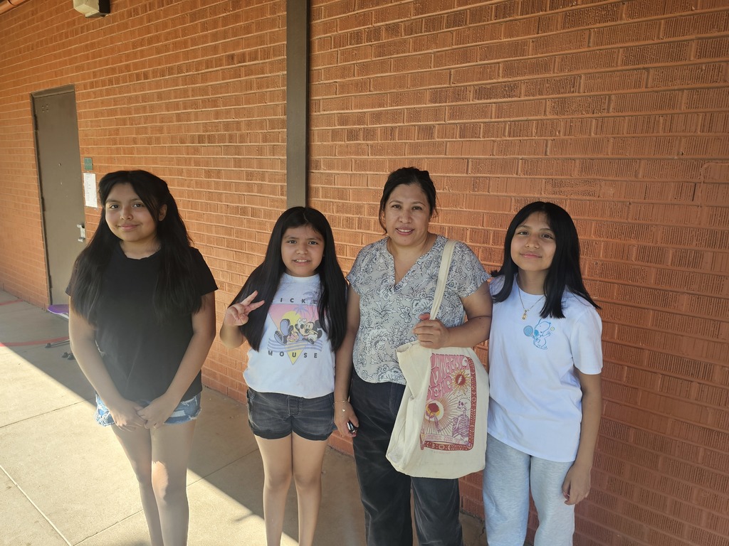 Mother and 3 daughter smiling during their parent teacher conferences meeting at school