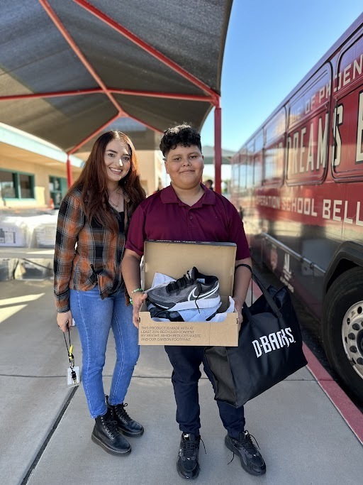 a student and staff member enjoying the excitement of operation school bell