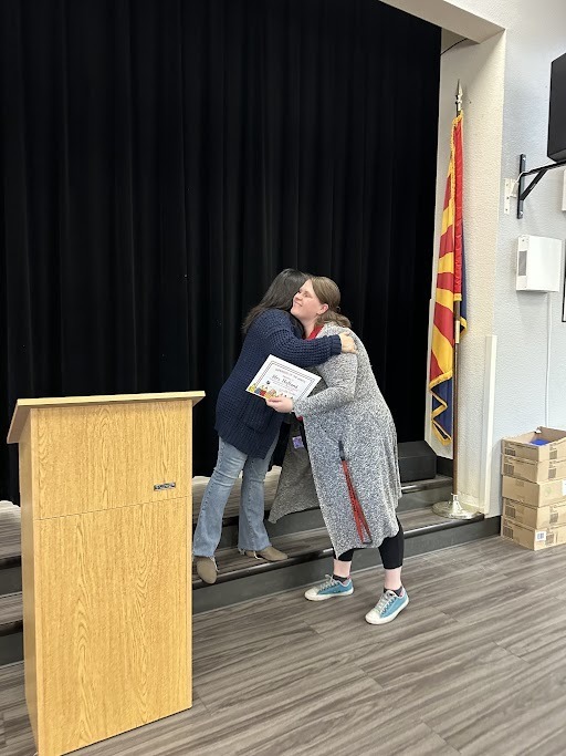 A staff member being recognized for staff member of the month