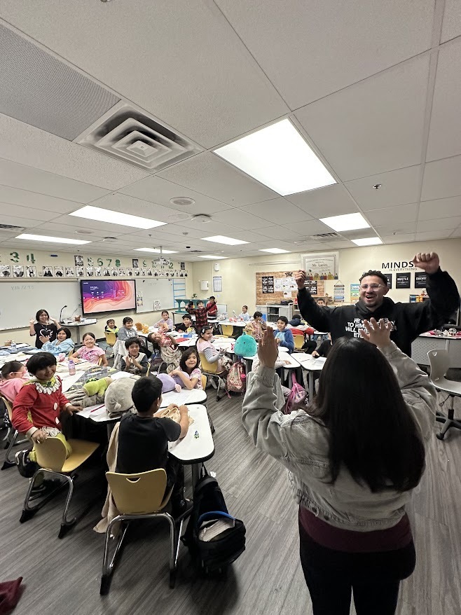 Mr. Larios and Mrs. Szabo and students cheering
