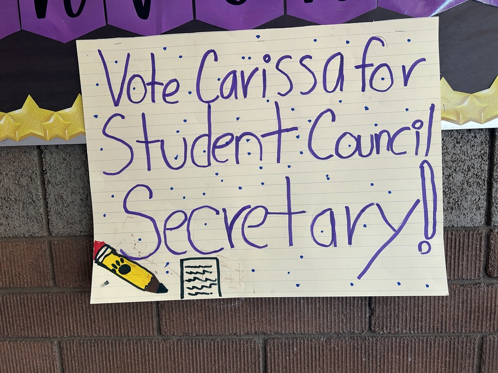 A simple poster in large purple handwriting that says, "Vote Carissa for Student Council Secretary!" with a drawing of a pencil and a notebook.