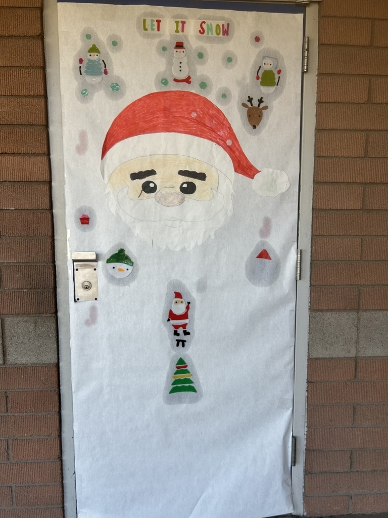 A door covered in white paper with the words "LET IT SNOW" at the top. A large, hand-drawn figure of Santa Claus wearing a red and white hat is centered, with various small drawings of snowmen, penguins, and other holiday figures scattered around him.