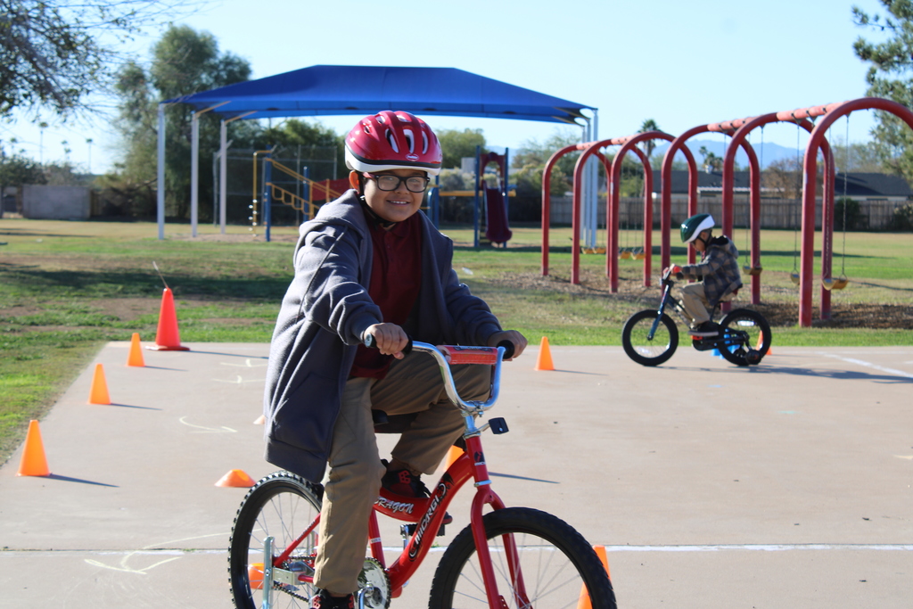 A young man riding a bike showing bicycle safety. 
