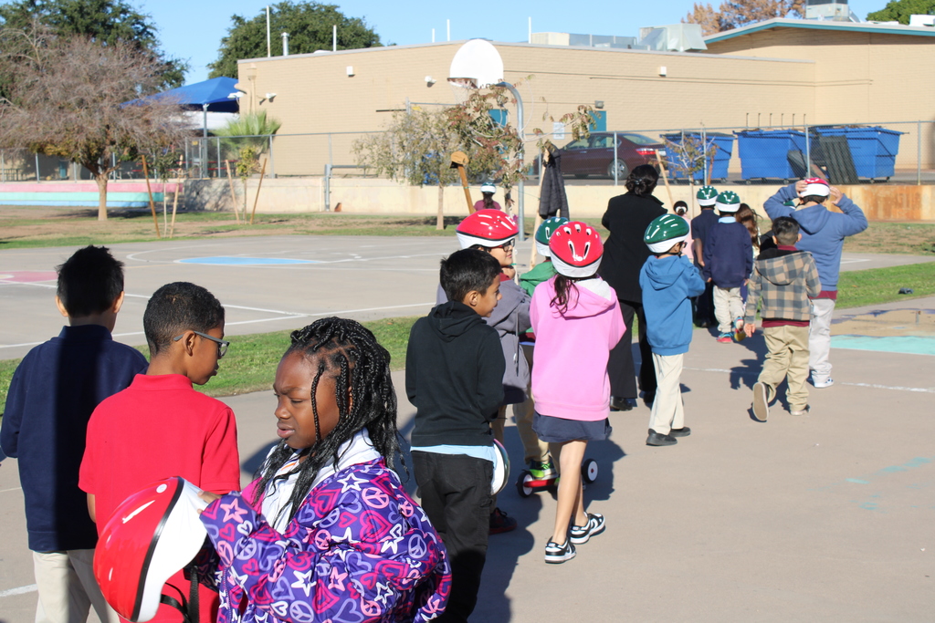 3rd graders walking to get a helmet