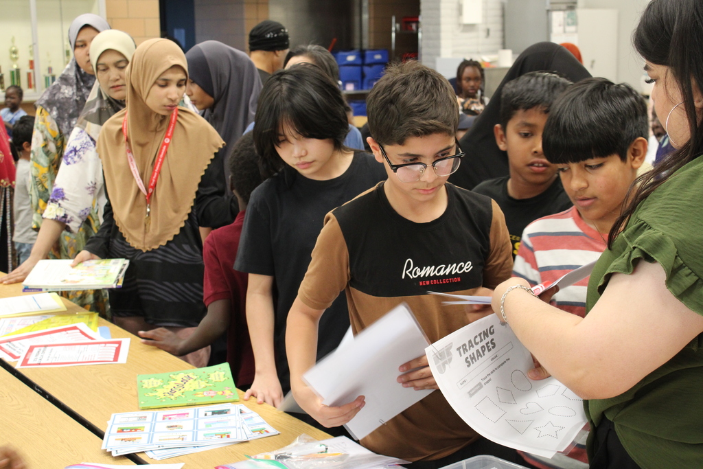 Students at Joseph Zito Elementary at Title 1 Family Night being given books