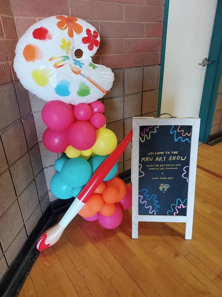 MKU art show welcome sign with art-themed balloons