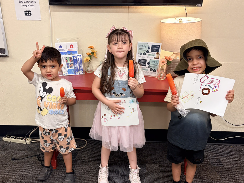 Students holding up picture they drew at Alta E Butler