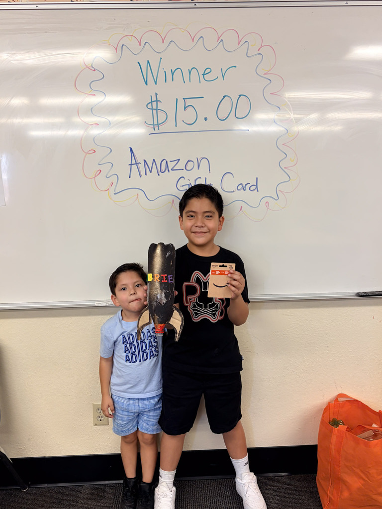 Students holding homemade rockets and Amazon gift card