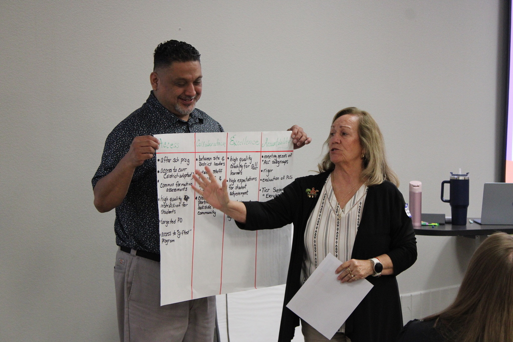 Assistant Principal Abel Flores and Dr. Ramona Ramirez explaining their ideas from the writing exercise