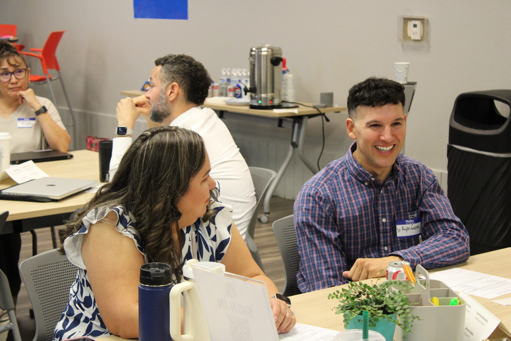 Principal Dr. Ryan Garza talking to fellow staff