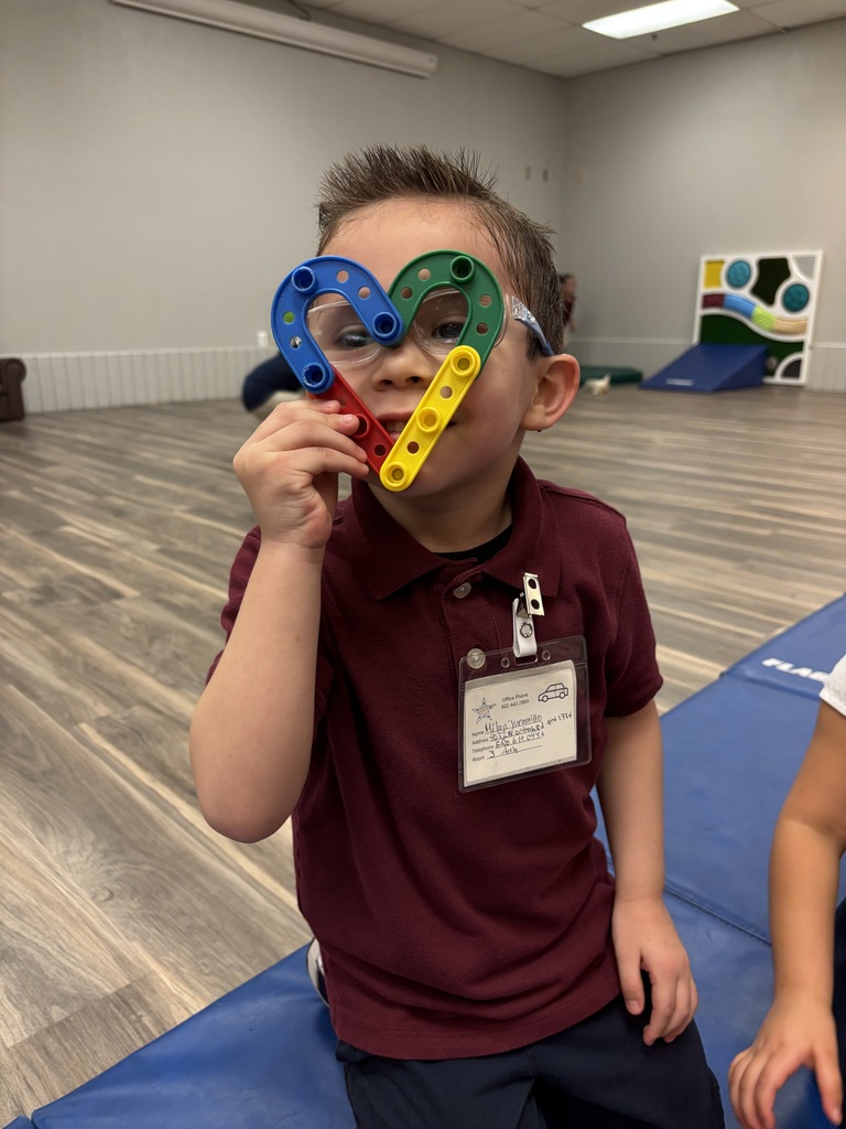 Boy holding up lego heart up to his face