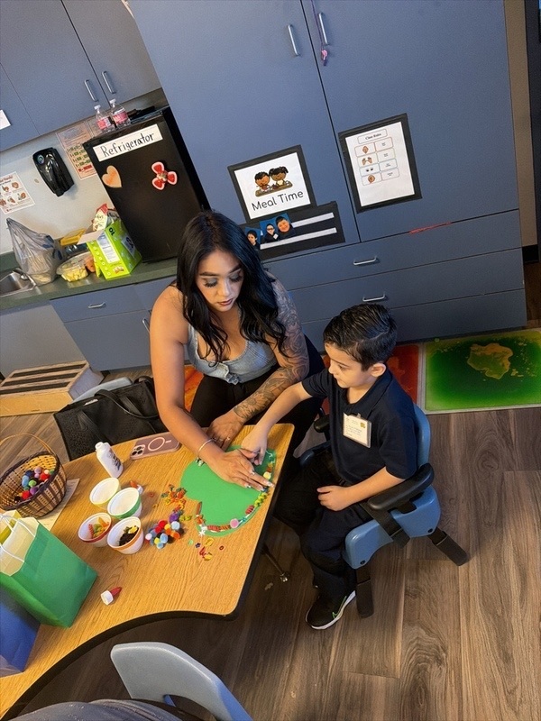 Mom and son doing a project in class