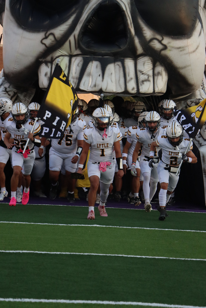 Varsity football team enters the field