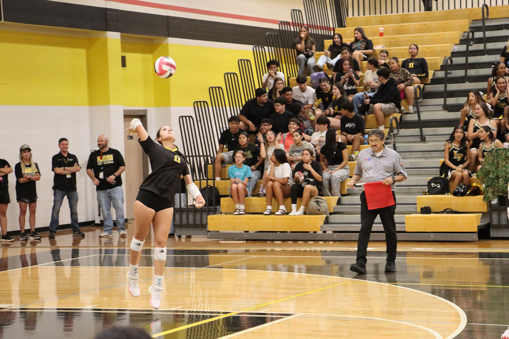 Volleyball player Lillian Evans serving the ball