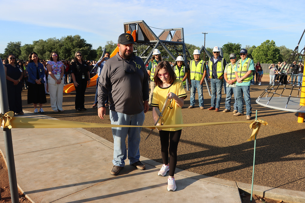 Lizzy Duty cutting ribbon at playground opening