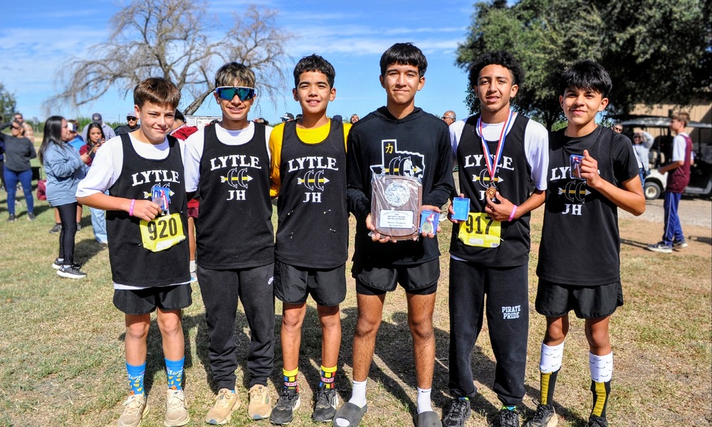8th Grade Boys Cross Country Team with championship plaque