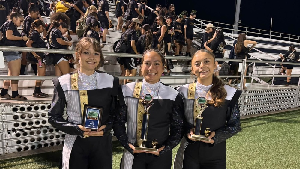 Pirate Band drum majors with trophies