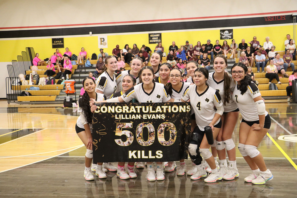 The volleyball team celebrates Lillian Evans' 500th kill