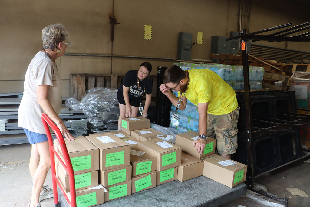 Students and staff helping with sorting textbooks.
