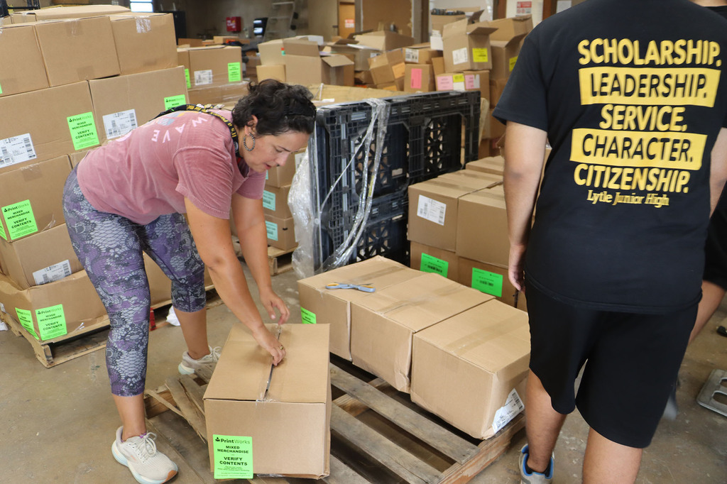 Students and staff helping with sorting textbooks.