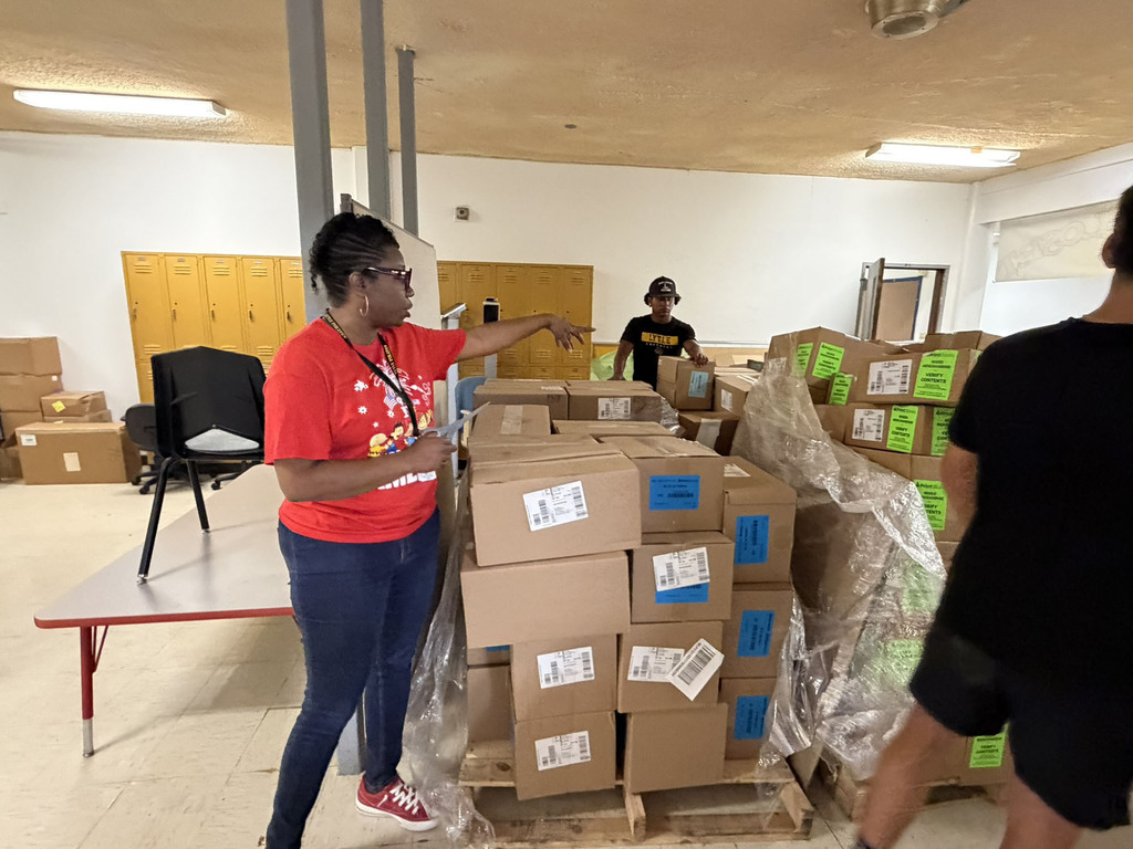 Students and staff helping with sorting textbooks.