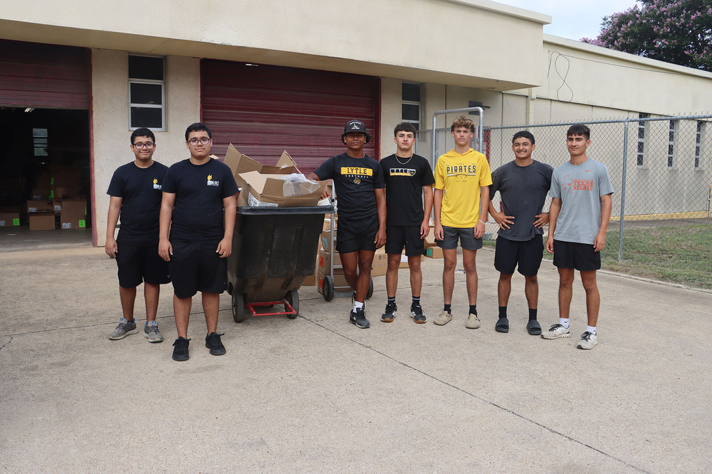 Students and staff helping with sorting textbooks.
