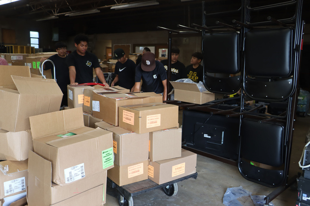 Students and staff helping with sorting textbooks.