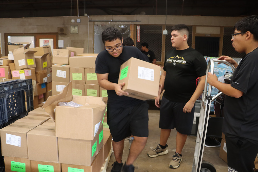 Students and staff helping with sorting textbooks.