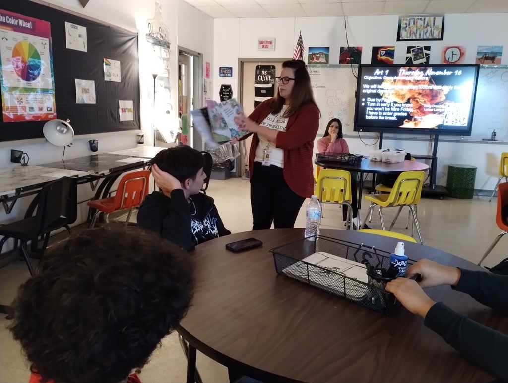 Dr Tanya Tate reads to the high school art class.