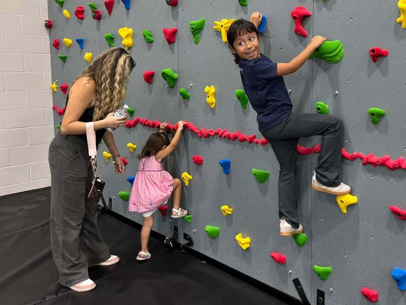Children using the new climbing wall at the Primary gym