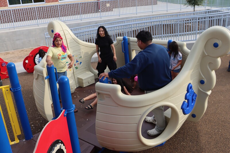 Children and adults on the ADA accessible playground Pirate ship